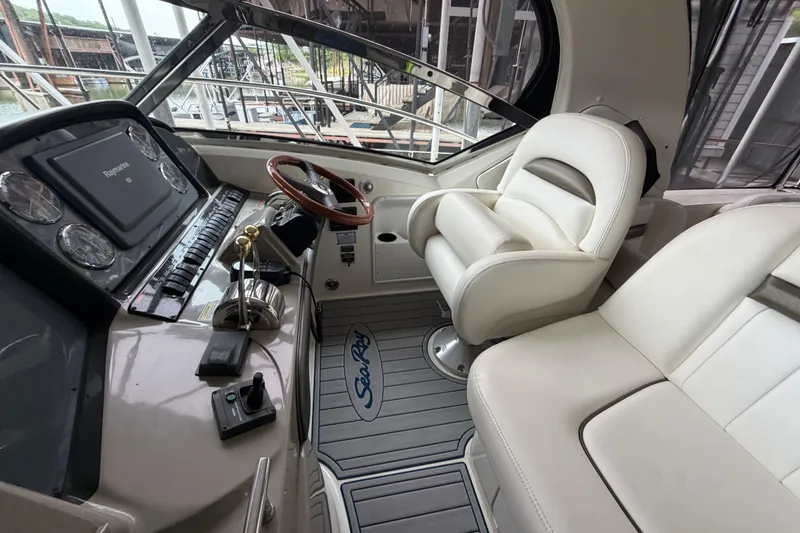 Slide: The Image of Interior helm of 2006 Sea Ray 40 Sundancer yacht with leather seating and navigation controls. - 4