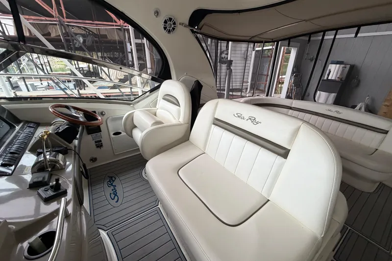 Slide: The Image of 2006 Sea Ray 40 Sundancer interior with white seating and helm station. - 5
