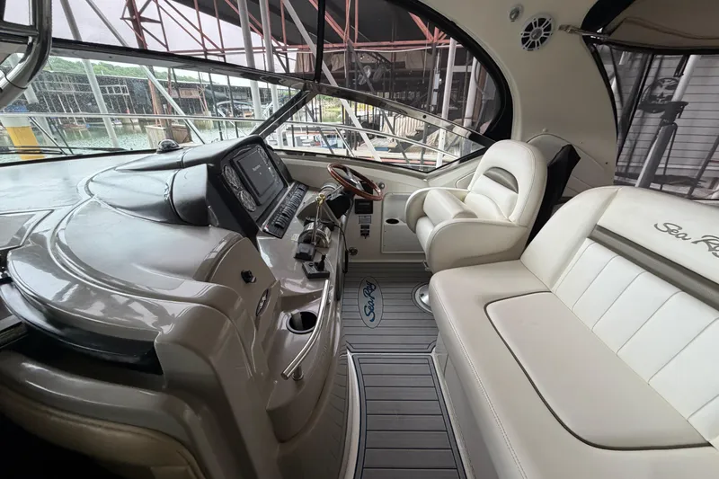 Slide: The Image of 2006 Sea Ray 40 Sundancer cockpit with luxurious seating and modern navigation controls. - 6