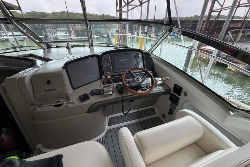 Slide: The Image of 2006 Sea Ray 40 Sundancer helm with steering wheel and navigation equipment. - 7