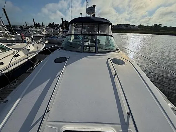 Slide: The Image of 2007 Sea Ray 320 Sundancer docked at marina, front deck view. - 12