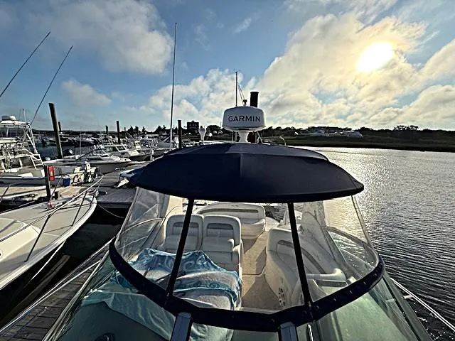 Slide: The Image of 2007 Sea Ray 320 Sundancer docked at marina, sunny day, Garmin radar visible. - 13