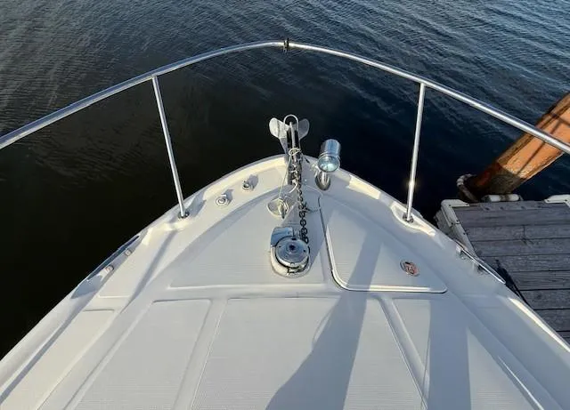 Slide: The Image of Bow of 2007 Sea Ray 320 Sundancer yacht docked by calm water. - 14