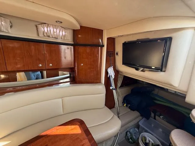 Slide: The Image of Interior of 2007 Sea Ray 320 Sundancer with TV, seating, and wooden cabinets. - 17