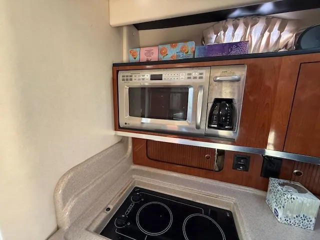 Slide: The Image of Galley kitchen in 2007 Sea Ray 320 Sundancer with microwave and stovetop. - 18