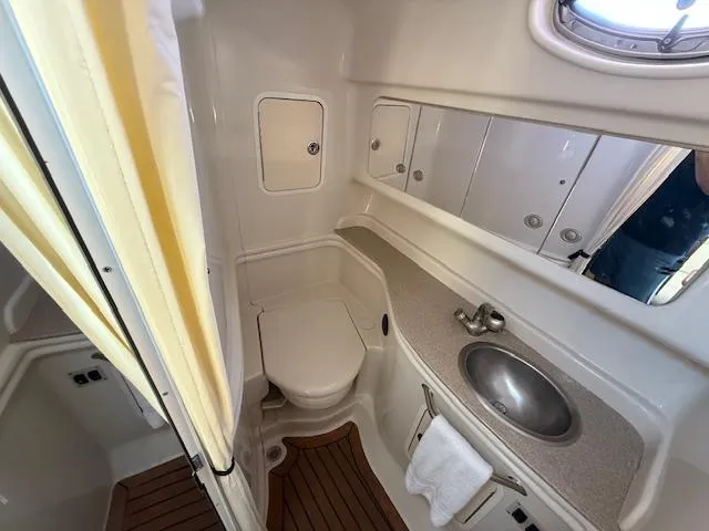Slide: The Image of 2007 Sea Ray 320 Sundancer bathroom with sink, toilet, and mirror. - 21