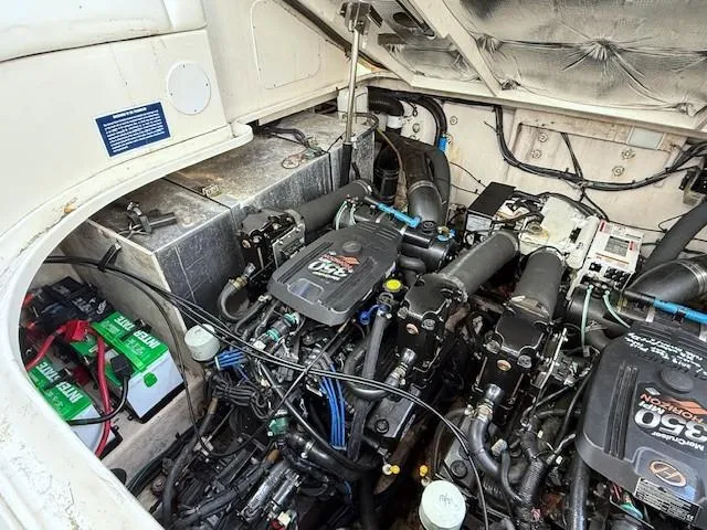 Slide: The Image of Engine compartment of a 2007 Sea Ray 320 Sundancer with dual engines and batteries. - 25