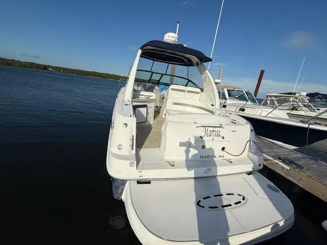 Slide: The Image of 2007 Sea Ray 320 Sundancer docked, rear view, sunny day, calm water. - 4