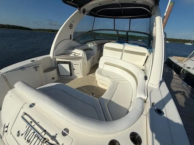 Slide: The Image of 2007 Sea Ray 320 Sundancer boat with spacious white seating on a sunny day. - 5
