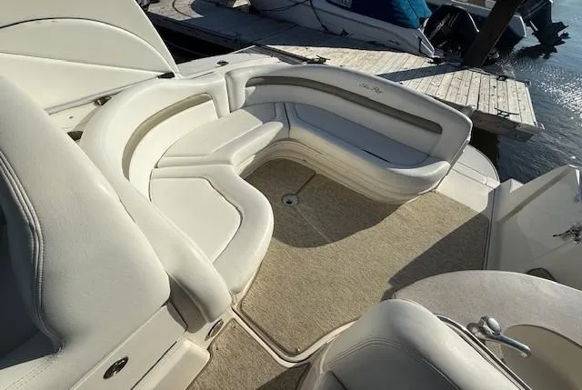 Slide: The Image of 2007 Sea Ray 320 Sundancer boat interior with white seating and beige carpet. - 6