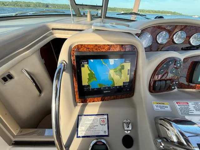 Slide: The Image of 2007 Sea Ray 320 Sundancer dashboard with GPS navigation system and control panel. - 9
