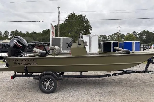 The Image of 2026 Lowe Roughneck RX1860 CC boat on trailer, parked outdoors. - 0