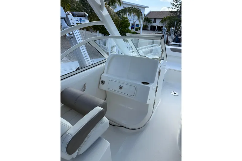 Slide: The Image of 2023 World Cat 255 DC boat interior with seating and console, showcasing modern design. - 11