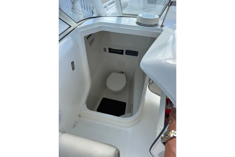 Slide: The Image of 2023 World Cat 255 DC boat interior with compact marine toilet. - 13