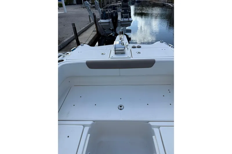 Slide: The Image of 2023 World Cat 255 DC boat interior, featuring spacious deck and sleek design by the water. - 14