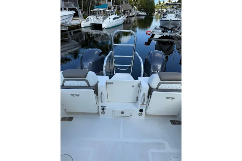 Slide: The Image of 2023 World Cat 255 DC boat with dual engines docked in a marina. - 5