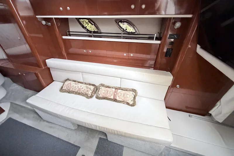 Slide: The Image of Interior of 2008 Sea Ray Sundancer 330 with white seating and decorative pillows. - 21