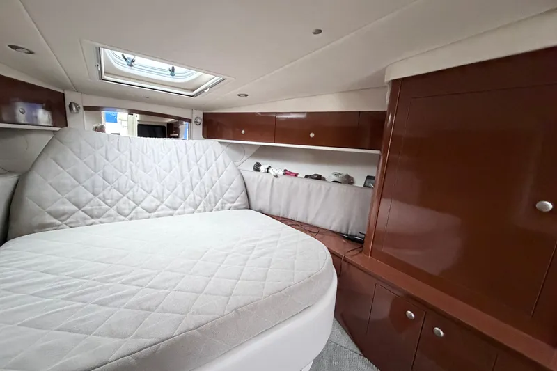 Slide: The Image of Interior cabin of 2008 Sea Ray Sundancer 330 with cozy bed and wooden cabinetry. - 25