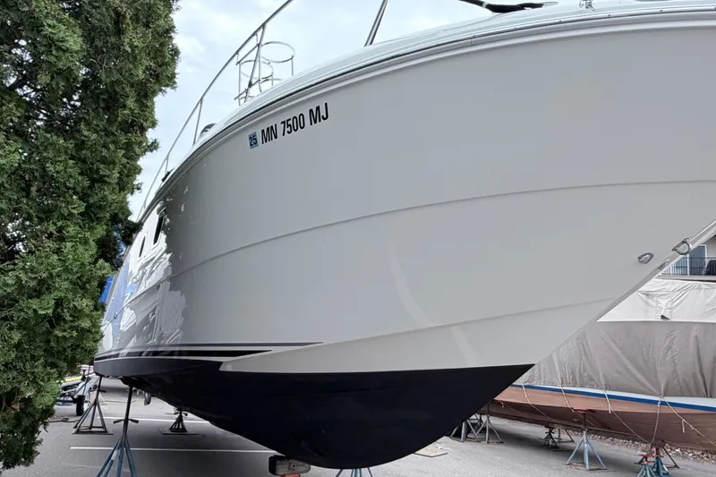 Slide: The Image of 2008 Sea Ray Sundancer 330 boat on stands, side view with registration number visible. - 29
