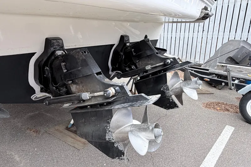 Slide: The Image of 2008 Sea Ray Sundancer 330 boat with dual propellers and stern drives in a parking area. - 40
