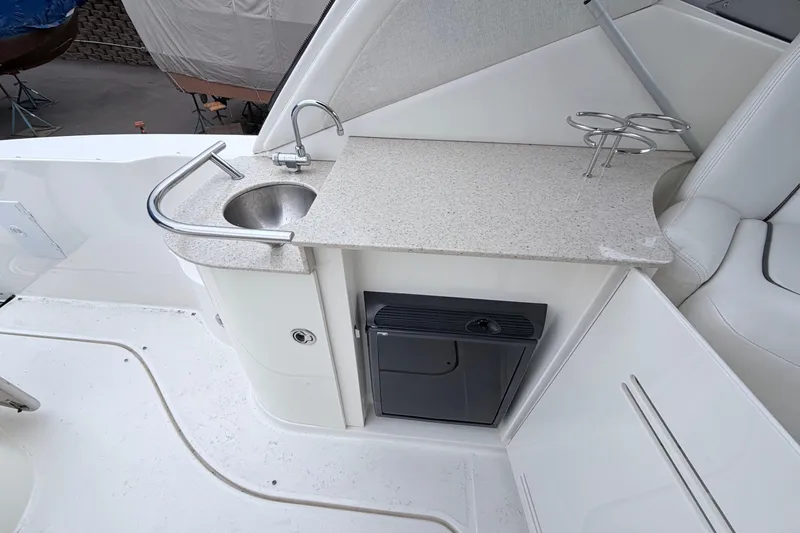 Slide: The Image of 2008 Sea Ray Sundancer 330 boat interior with sink, countertop, and mini fridge. - 7