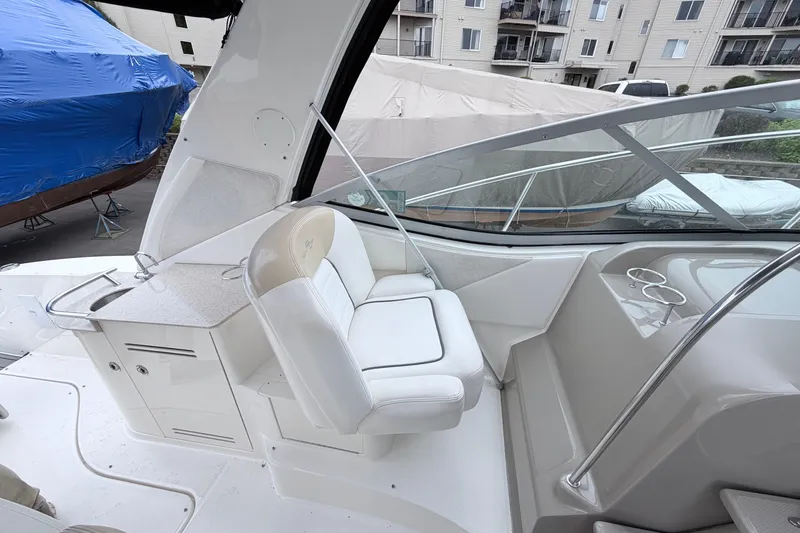 Slide: The Image of 2008 Sea Ray Sundancer 330 cockpit with white seating and sleek design. - 8
