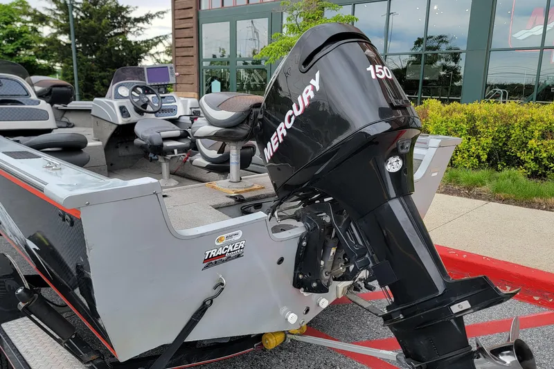 Slide: The Image of 2006 Tracker Targa 185 SC boat with Mercury 150 engine, parked outdoors. - 11