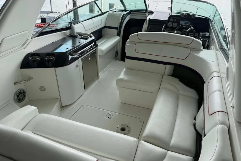 Slide: The Image of 2018 Formula 310 Sun Sport boat interior with white seating and sleek dashboard. - 11