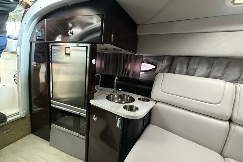 Slide: The Image of Interior of 2018 Formula 310 Sun Sport boat with kitchenette and seating area. - 14