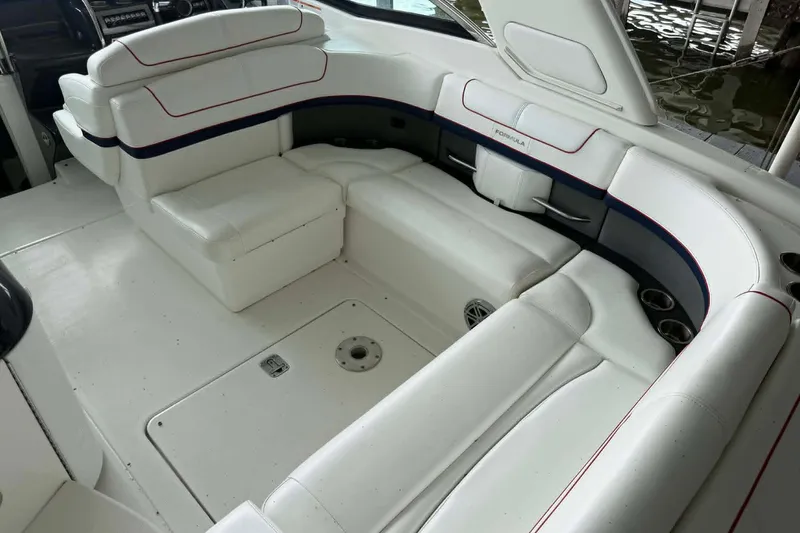 Slide: The Image of 2018 Formula 310 Sun Sport boat interior with white seating and cup holders. - 17