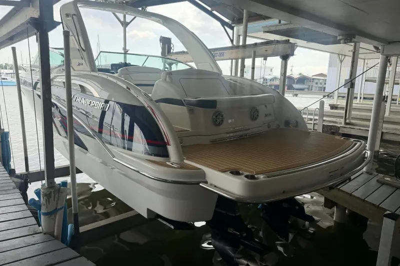 Slide: The Image of 2018 Formula 310 Sun Sport boat docked in a marina, rear view. - 2