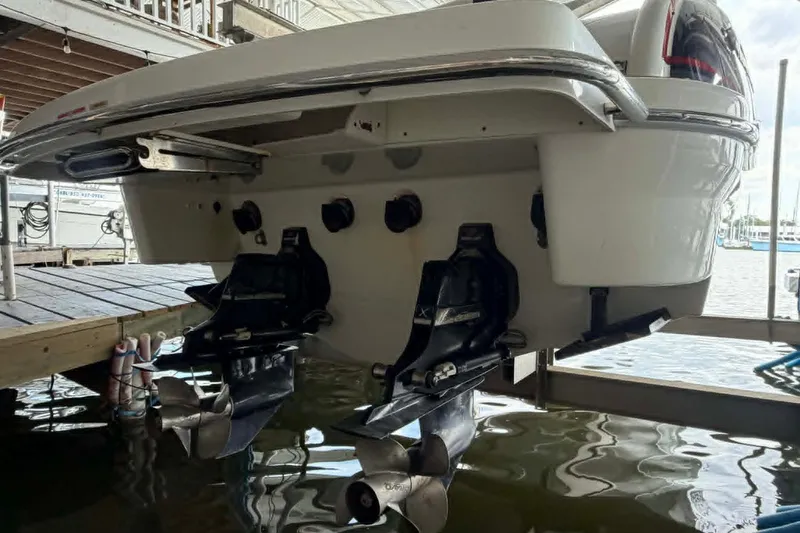 Slide: The Image of 2018 Formula 310 Sun Sport boat stern with dual propellers in marina setting. - 7