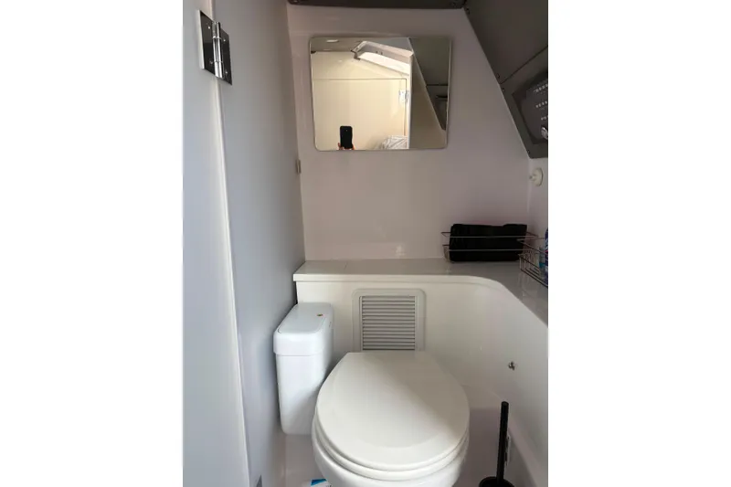 Slide: The Image of 2024 Axopar 37 XC Cross Cabin bathroom with modern fixtures and mirror. - 15