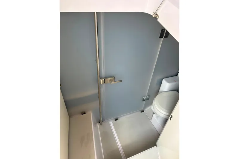 Slide: The Image of 2024 Axopar 37 XC Cross Cabin bathroom interior with modern fixtures and sleek design. - 13