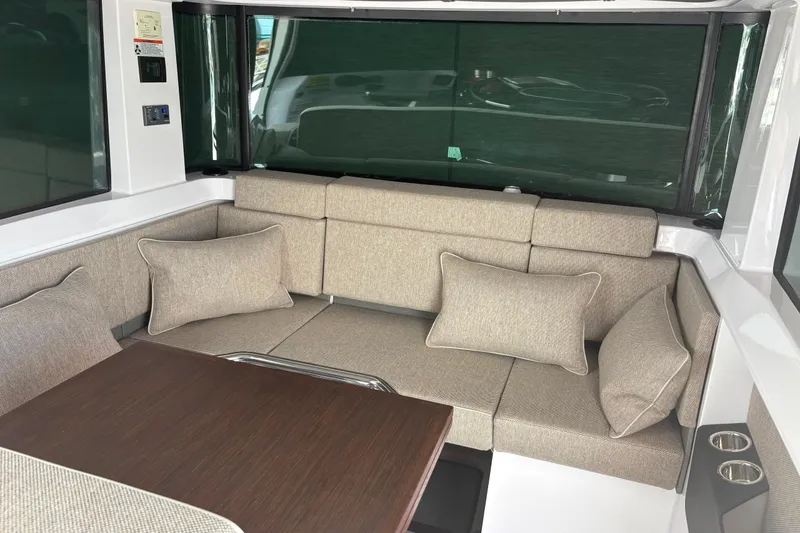 Slide: The Image of Luxurious interior of 2024 Axopar 37 XC Cross Cabin with plush seating and table. - 10