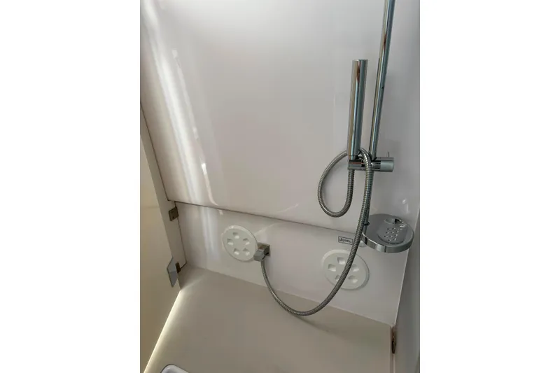 Slide: The Image of Shower area in 2024 Axopar 37 XC Cross Cabin, featuring sleek chrome fixtures. - 14