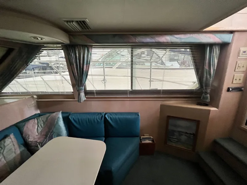 Slide: The Image of Interior of a 1991 Hatteras 40 DC yacht with seating area. - 13