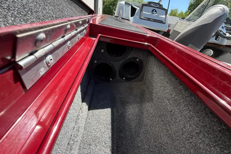 Slide: The Image of Interior view of a 2016 Bass Tracker Tournament V-18 boat compartment with red trim. - 10