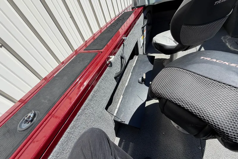 Slide: The Image of Interior of a 2016 Bass Tracker Tournament V-18 boat with seating and storage compartments. - 11
