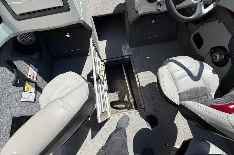 Slide: The Image of 2016 Bass Tracker Tournament V-18 boat interior with open storage compartment and seating. - 12