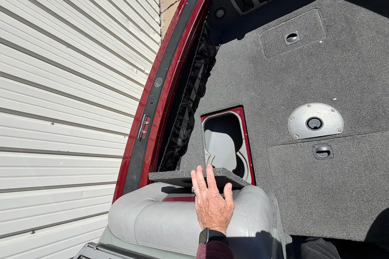 Slide: The Image of 2016 Bass Tracker Tournament V-18 boat interior with storage compartment and seating. - 13