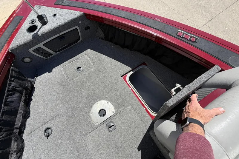Slide: The Image of 2016 Bass Tracker Tournament V-18 boat interior with storage compartment open. - 14