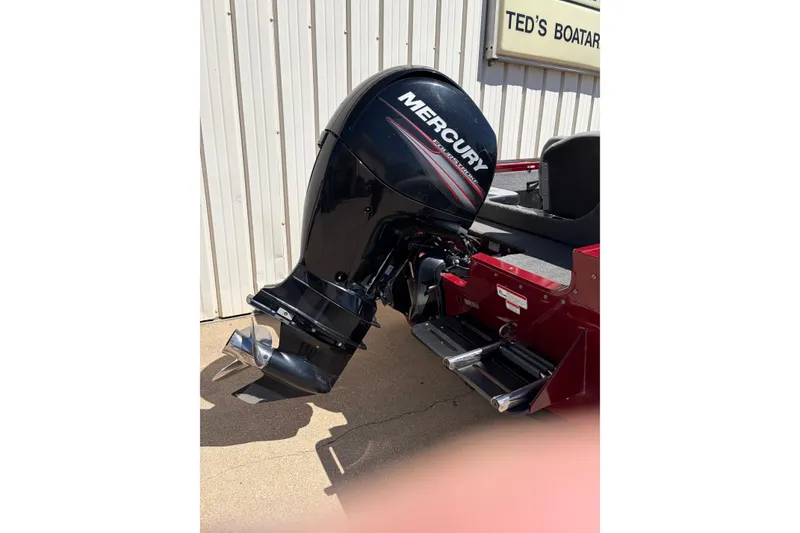 Slide: The Image of 2016 Bass Tracker Tournament V-18 with Mercury outboard motor, parked near Ted's Boatarama. - 16