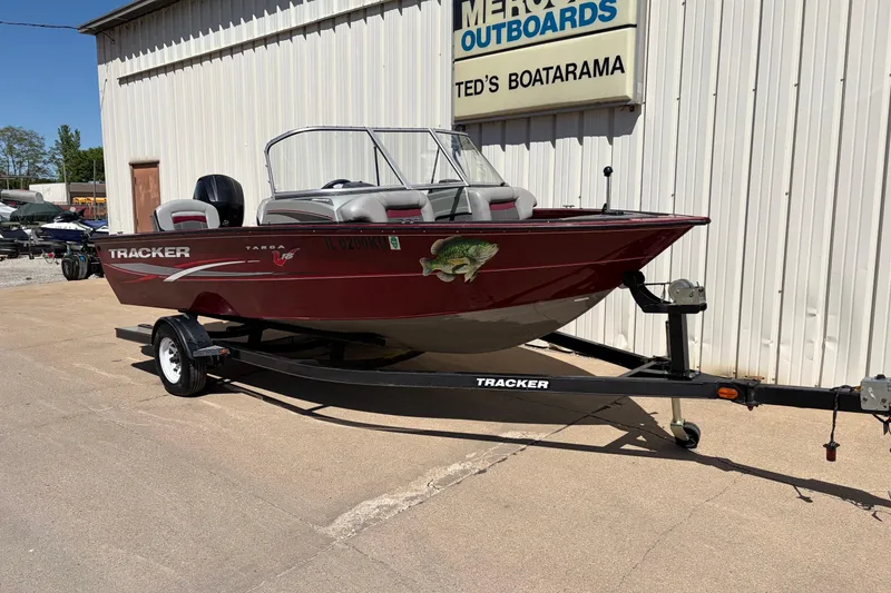 Slide: The Image of 2016 Bass Tracker Tournament V-18 boat on trailer outside Ted's Boatarama. - 19