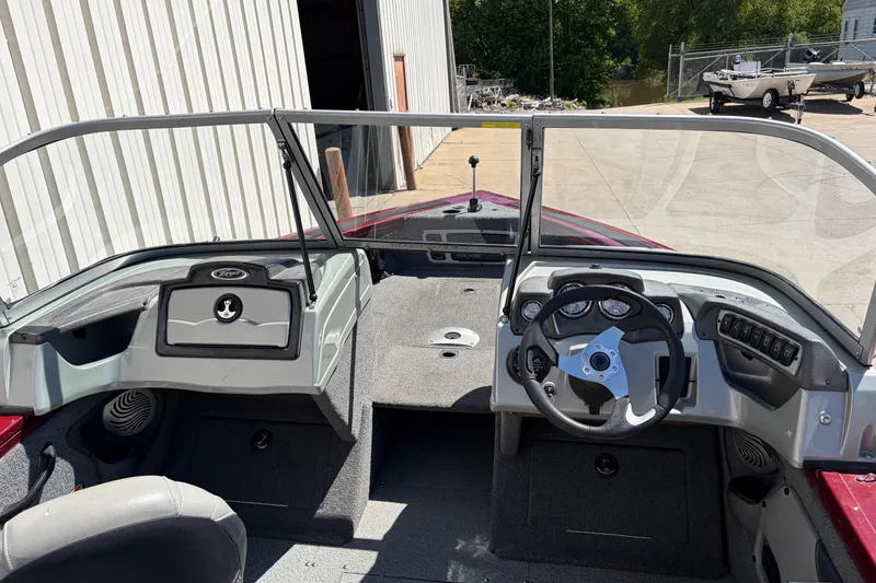 Slide: The Image of 2016 Bass Tracker Tournament V-18 boat interior with steering wheel and dashboard controls. - 21