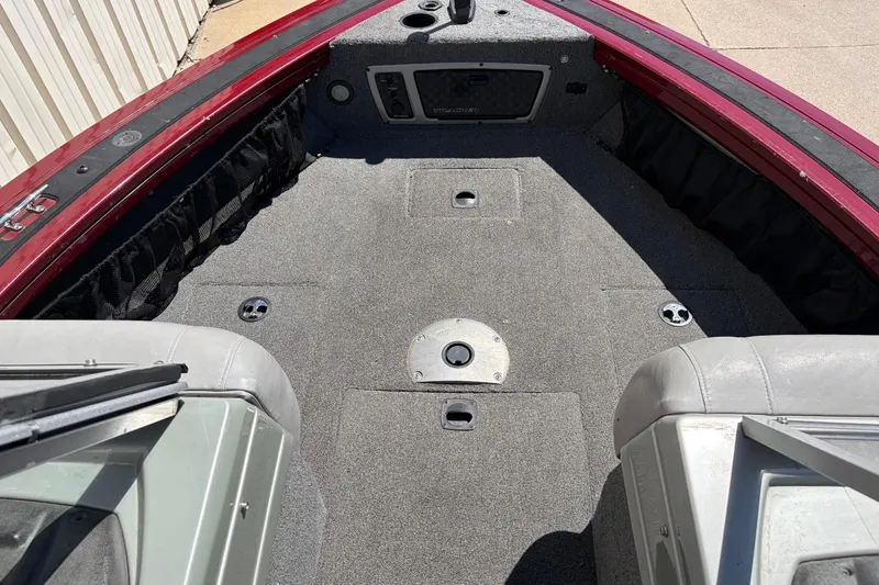 Slide: The Image of 2016 Bass Tracker Tournament V-18 boat interior with gray carpet and seating. - 22