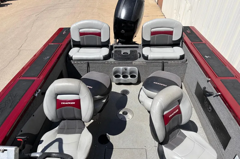 Slide: The Image of 2016 Bass Tracker Tournament V-18 boat interior with seating and storage compartments. - 23