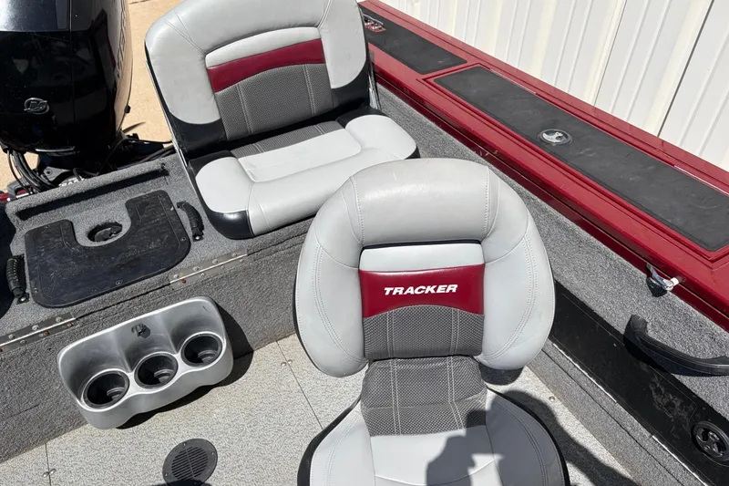Slide: The Image of 2016 Bass Tracker Tournament V-18 boat interior with cushioned seats and cup holders. - 25