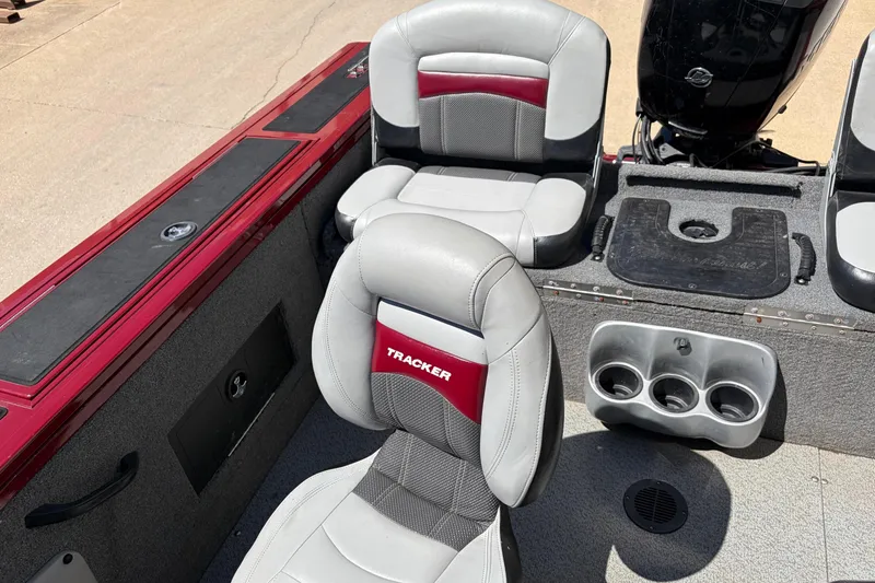 Slide: The Image of 2016 Bass Tracker Tournament V-18 boat interior with cushioned seats and cup holders. - 26