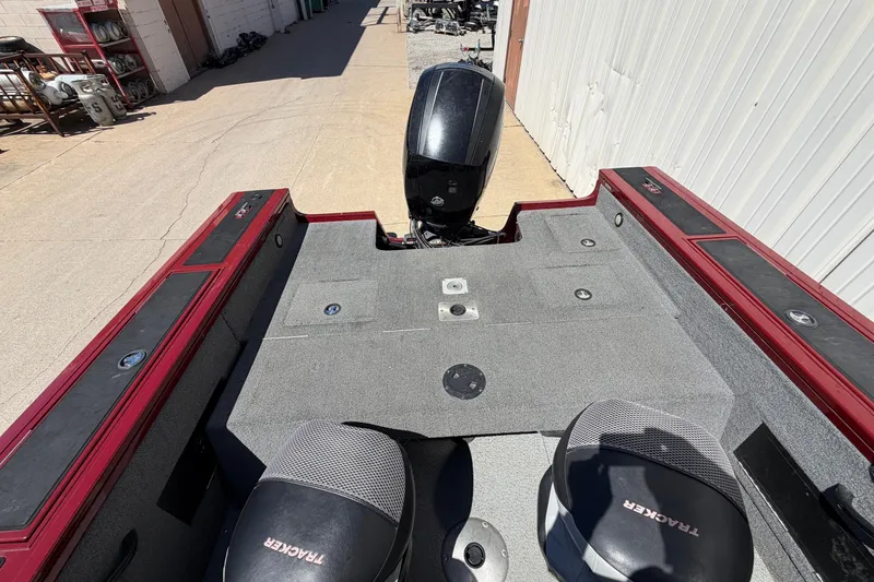 Slide: The Image of 2016 Bass Tracker Tournament V-18 boat interior with motor and seating. - 27